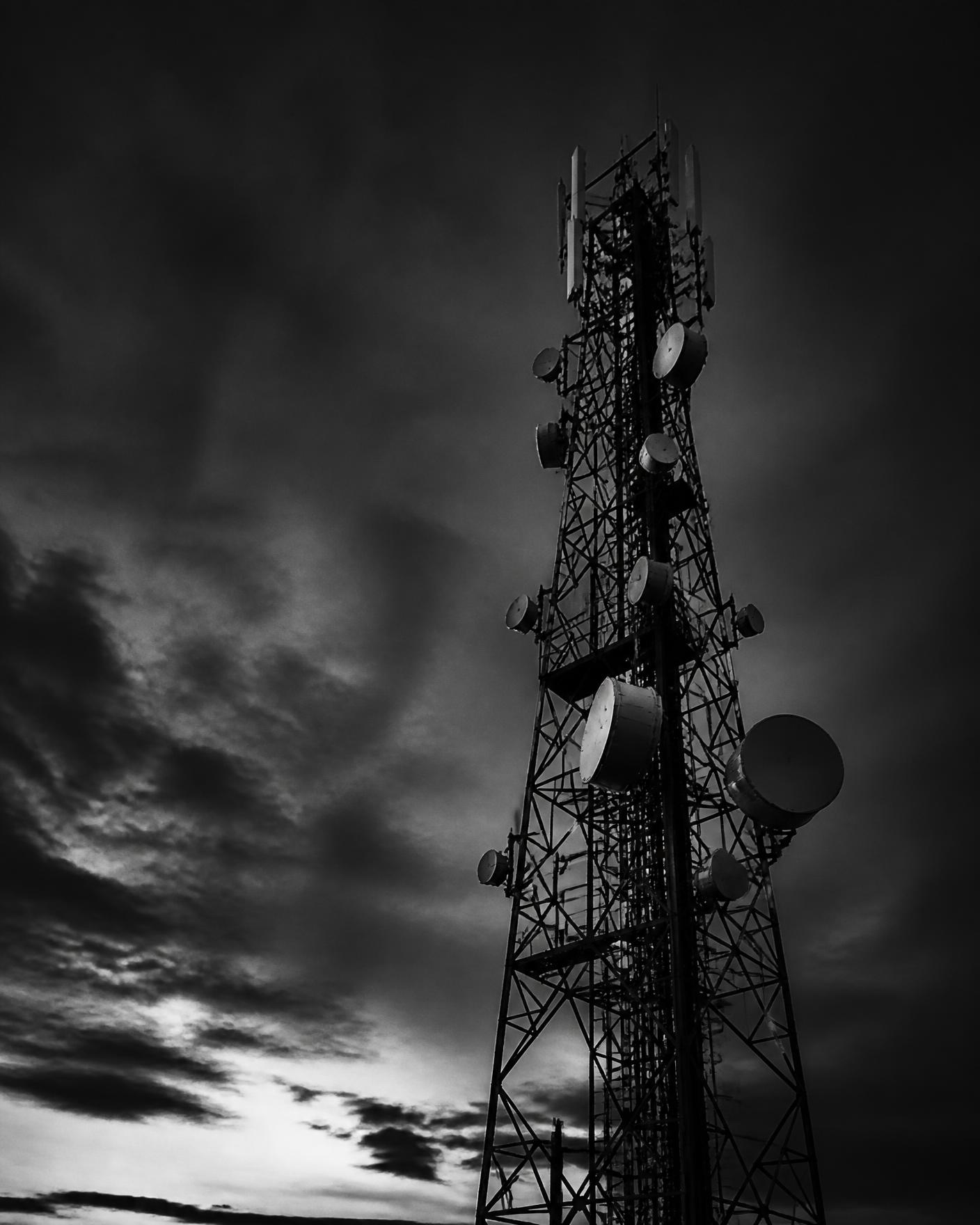 Telecommunications tower against a dramatic sky